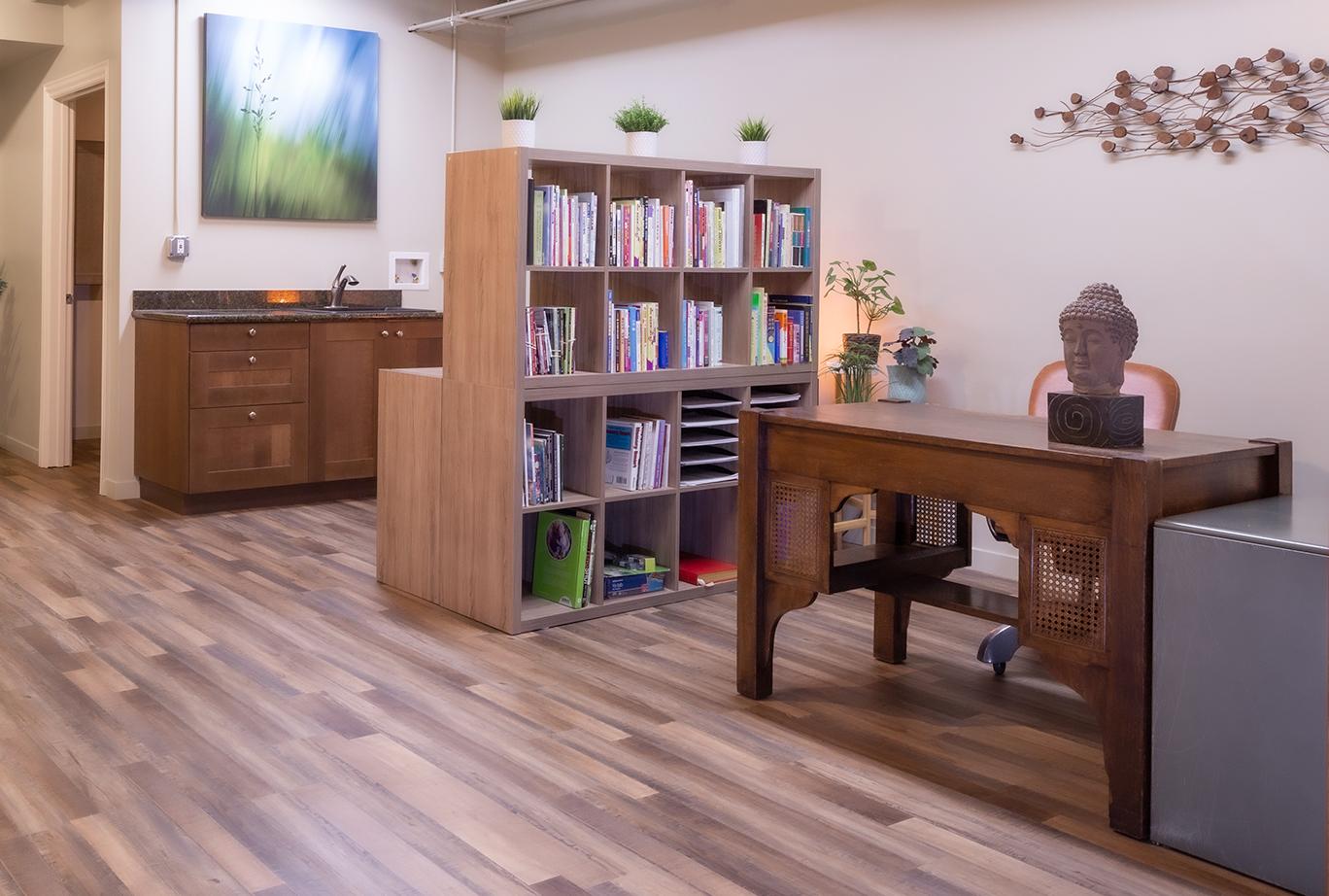 The bookcases between the office and kitchenette divide the areas and add storage, but they don't feel heavy. They also provide another opportunity to add some greenery.