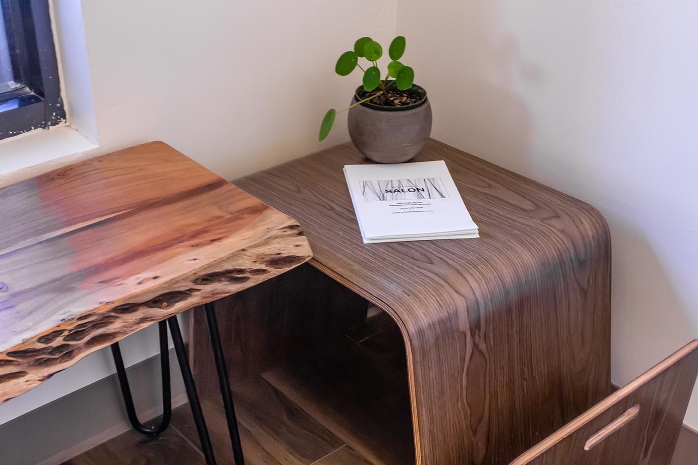 The waiting area has benches with live edges and a side table that contains printed material I designed with a price list.