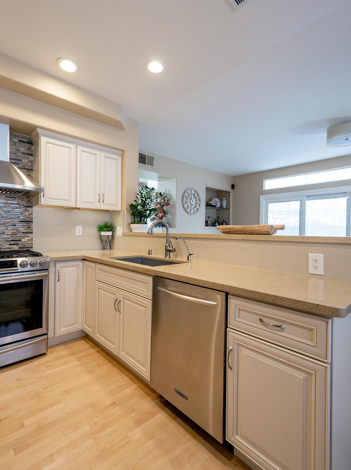 Side of kitchen with bar overlooking the dining area and fireplace